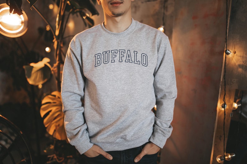 May include: A gray sweatshirt with the word "BUFFALO" printed in black on the front.