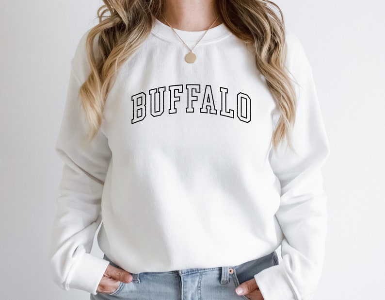 May include: White sweatshirt with black text that reads "BUFFALO" in a collegiate font.