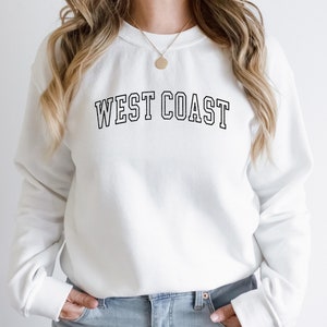 May include: White sweatshirt with black text that reads "WEST COAST" in a collegiate font.