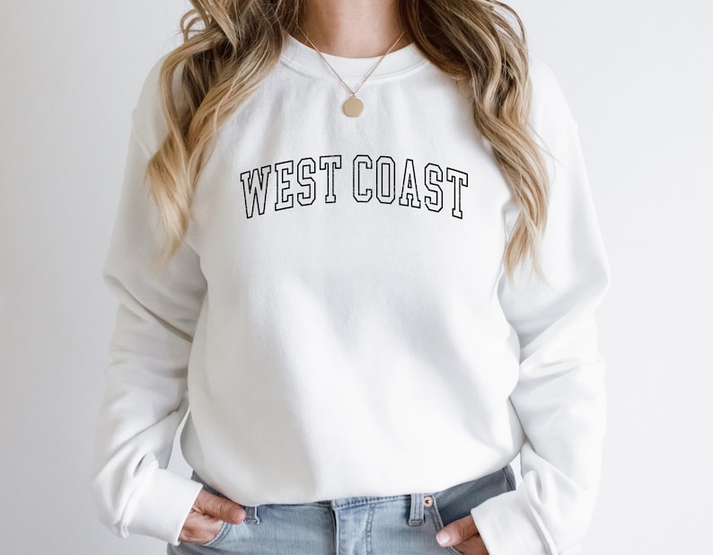 May include: White sweatshirt with black text that reads "WEST COAST" in a collegiate font.