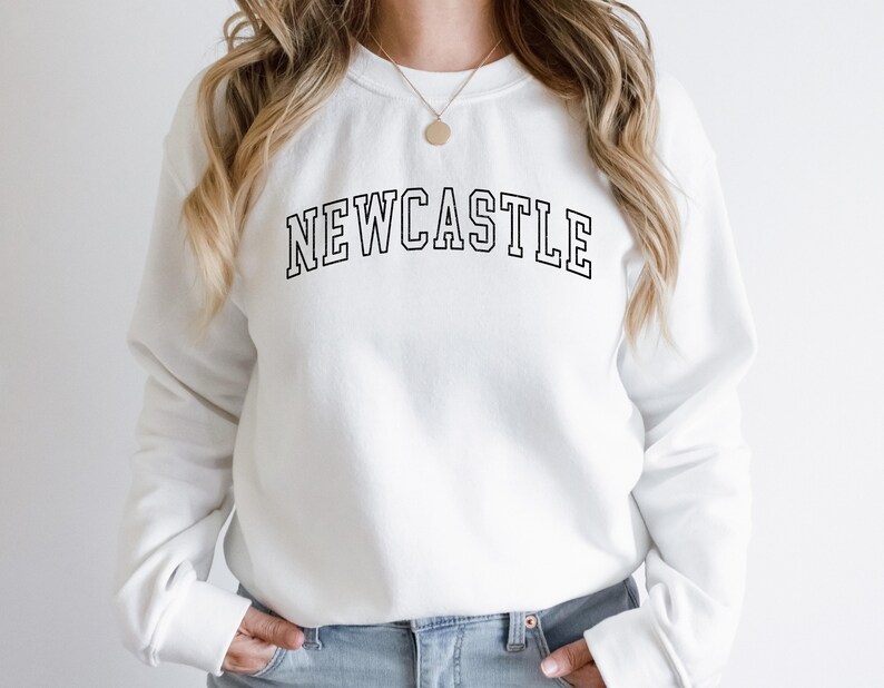 May include: White sweatshirt with black text that reads "NEWCASTLE" in a collegiate font.