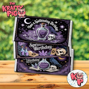 May include: Three stacked candy bar boxes with a dark purple, witchy theme. Each box features illustrations of potion bottles, crystals, skulls, and ravens. Text includes "Have a Spellbinding Birthday" and "Spellbinding Birthday".