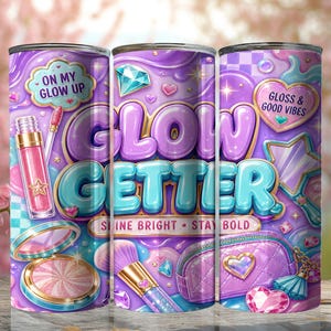 May include: A cylindrical tumbler featuring a purple and teal background with the text GLOW GETTER, ON MY GLOW UP, GLOSS & GOOD VIBES, and SHINE BRIGHT STAY BOLD. The design includes illustrations of lip gloss, a makeup brush, a compact, and a pouch.