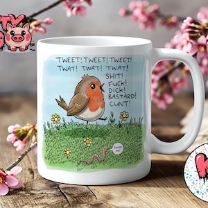 May include: White ceramic mug with a cartoon robin on a grassy field, featuring humorous text. The mug has a large handle and a round base. The Krafty Pig logo is visible on the mug and on a coaster.