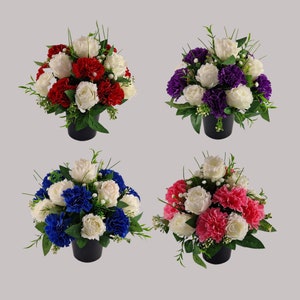 May include: Four artificial flower arrangements in black pots. Each arrangement features white, red, purple, and blue roses with greenery.