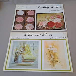 May include: Two painting instruction books, "Fantasy Flowers" and "Petals and Places", both by Georgia Bartlett and presented by Susan Scheewe. The covers feature floral paintings.