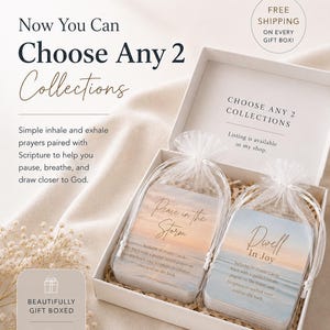 May include: A white gift box containing two sets of prayer cards in sheer white organza drawstring bags. Each card set features a sunset beach scene with the text Peace in the Storm and Dwell In Joy, including 30 cards with guided prayers.