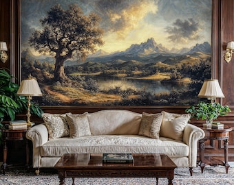 May include: A living room interior with a large landscape painting above a white sofa with pillows. The painting depicts a lake, mountains, and a large tree. Two lamps with cream-colored shades are on end tables on either side of the sofa. A wooden coffee table sits in front of the sofa.