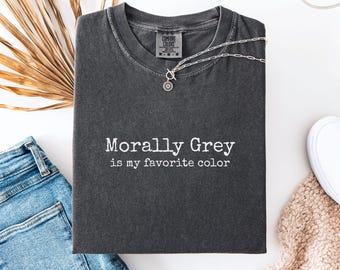 May include: A white ceramic mug with a black handle and the text "But First, Coffee" in a black, bold font. The mug is on a white surface. The mug is likely for hot beverages.