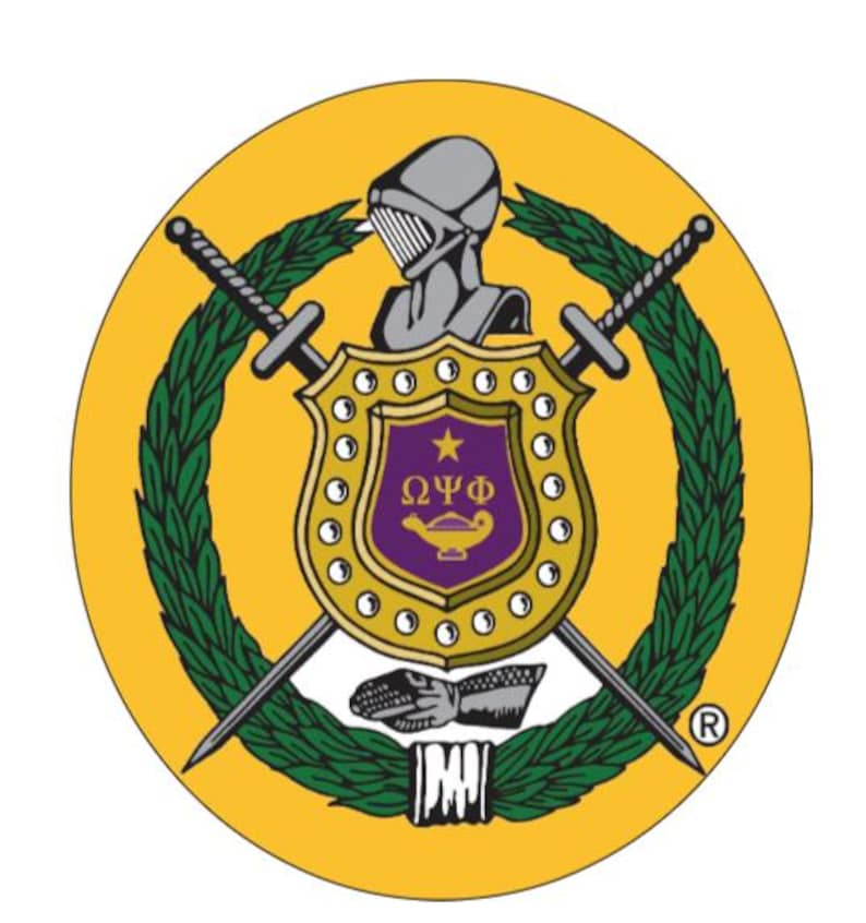 May include: A circular emblem with a gold background features a shield with a purple interior and gold trim. The shield is flanked by crossed swords and surrounded by a green wreath. A knight's helmet sits above the shield. The emblem includes the letters "&Omega;&Psi;&Phi;".