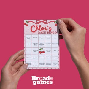 May include: A pink and white "Chloe's Bach Bingo" game card with a cherry design. The card features a grid of squares with various prompts for a hen party. The Broad Games logo is at the bottom.