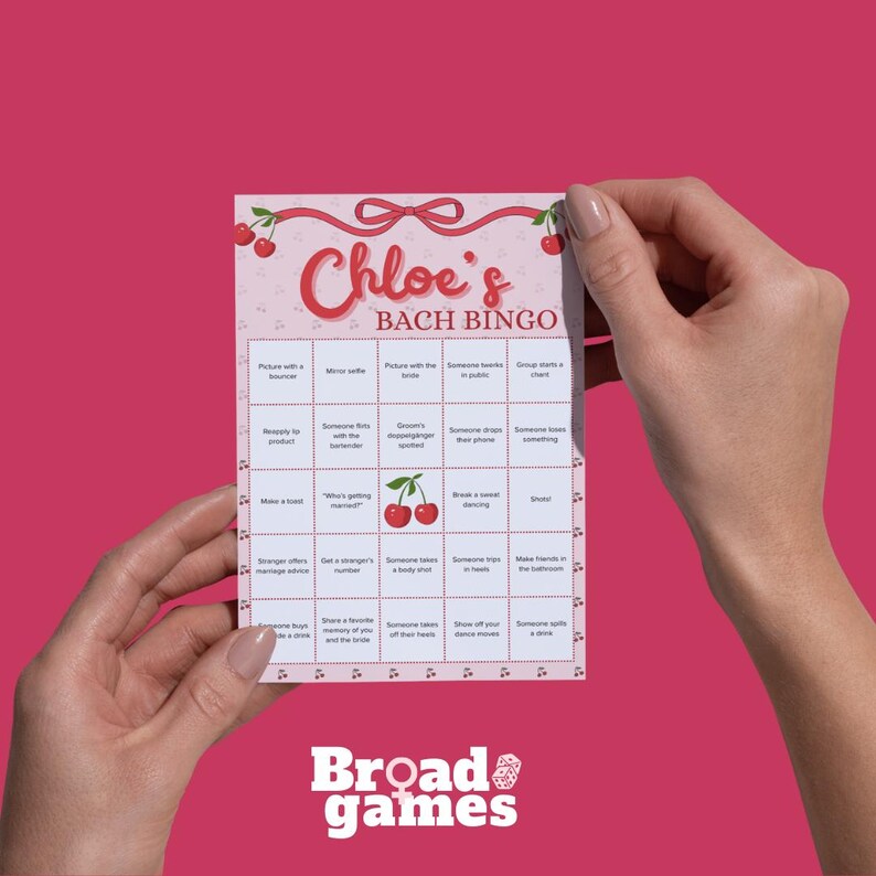 May include: A pink and white "Chloe's Bach Bingo" game card with a cherry design. The card features a grid of squares with various prompts for a hen party. The Broad Games logo is at the bottom.