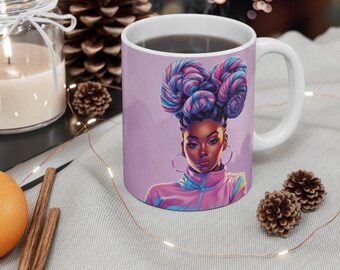 May include: White ceramic coffee mug featuring a portrait of a woman with purple, blue, and pink hair. The woman is wearing a pink and blue jacket and large hoop earrings. The mug is on a table with a candle and pinecones.