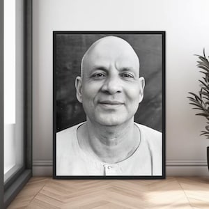 May include: Black and white portrait photograph of a man with a shaved head. He is wearing a white collared shirt and has a kind expression on his face.