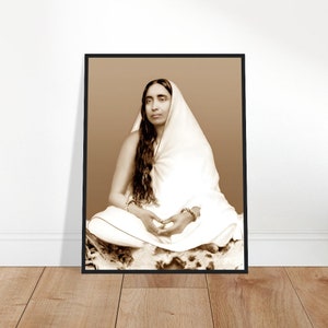 May include: A black and white portrait of a woman wearing a white shawl and sitting in a meditative pose.