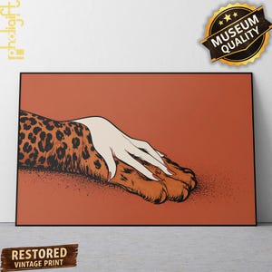 May include: A rectangular art print featuring a stylised illustration of a pale hand with red fingernails resting on a leopard-spotted animal paw. The artwork is set against a solid terracotta orange background with a black border frame.
