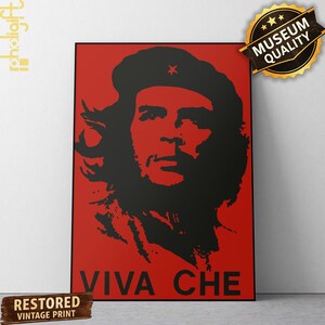 May include: A rectangular wall art print featuring a high-contrast black silhouette portrait of Che Guevara against a solid red background. The design includes a small red star on the beret and the black text VIVA CHE at the bottom of the print.