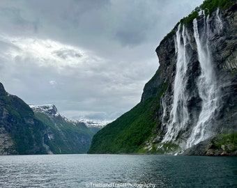 Moody Mountain Magic in the Norway Fjord. Seven Sisters Waterfall. Cloudy Moody Scenes into the Deep Water. Photos for Office and Travelers.