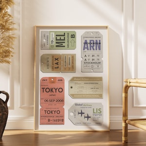 a scandinavian style home with a wood framed poster with personalised airport tags on it