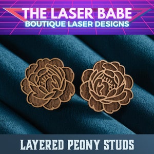 May include: A pair of layered wooden peony flower stud earrings. The earrings are made of dark brown wood and have a detailed design.