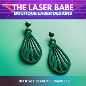 May include: A pair of green seashell dangle earrings with gold hooks. The earrings are made of laser-cut acrylic and have a delicate, intricate design. "DELICATE SEASHELL DANGLES" is written in white text on a dark green background.