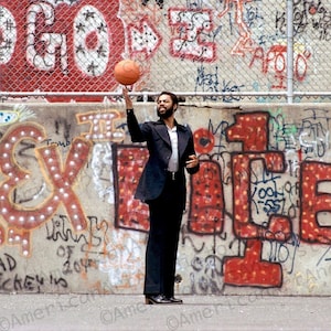 Walt Frazier Portrait in front of graffiti covered wall.