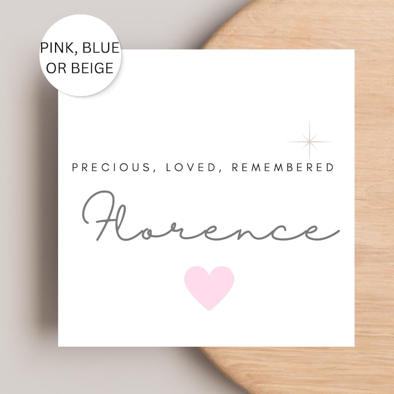 May include: A white square card with the name "Florence" in gray script, a pink heart, and the words "PRECIOUS, LOVED, REMEMBERED." A circular label at the top says "PINK, BLUE OR BEIGE."