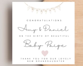 May include: A white card with a banner that says "OH BABY" in brown letters. The card has a gray script font that says "Congratulations Amy & Daniel on the birth of beautiful Baby Paige". There is a pink heart below the name and the text "Thank you for our lovely new granddaughter" at the bottom.