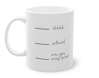 Puede incluir: Taza de café de cerámica blanca con texto negro que dice "shhhhh", "almost", y "now you may speak".