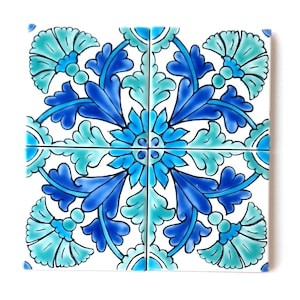 May include: A square ceramic tile with a blue and green floral pattern. The tile is divided into four sections, each with a different design. The center of the tile features a large, blue flower with a white center. The tile is surrounded by a white border.
