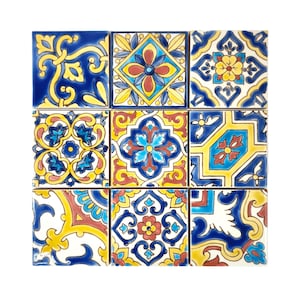 May include: A set of nine square ceramic tiles featuring intricate floral patterns in shades of blue, yellow, red, and white. The tiles are arranged in a 3x3 grid.
