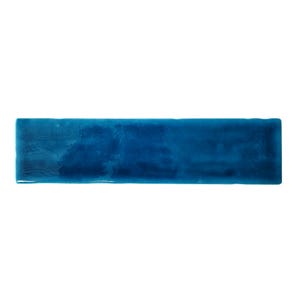 May include: A long, rectangular tile with a glossy, teal blue glaze. The tile has a slightly uneven surface, giving it a rustic look.
