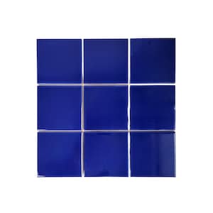 May include: Nine square, glossy, cobalt blue tiles arranged in a grid pattern. The tiles have a smooth, reflective surface and are evenly spaced, creating a clean, modern aesthetic. Ideal for a bathroom or kitchen backsplash.