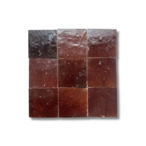 May include: Nine square, glazed ceramic tiles in varying shades of brown. The tiles are arranged in a three-by-three grid. The glaze has a glossy finish, and the tiles have a rustic, aged appearance. The colour ranges from dark brown to a lighter reddish-brown.