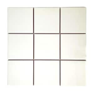 May include: A white ceramic tile sheet with nine individual tiles separated by thin brown lines.