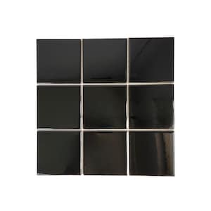 May include: Nine glossy black square tiles arranged in a grid pattern. The tiles are evenly spaced with white grout lines separating them. The tiles have a reflective surface, creating highlights and shadows.
