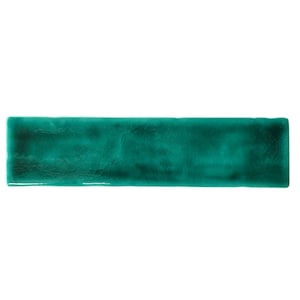 May include: A teal green ceramic tile with a textured surface.
