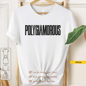 Peut inclure: Un t-shirt blanc avec le mot "POLYGLAMOROUS" imprimé en noir gras. Le t-shirt est présenté sur un cintre en bois. Du texte supplémentaire indique les options de personnalisation et la disponibilité des couleurs.