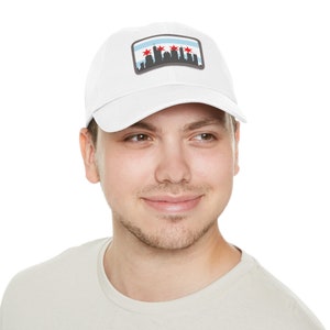May include: A white baseball cap with a patch featuring a skyline of Chicago with red stars on a blue and white background.