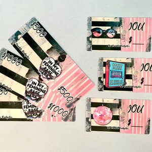 May include: A collection of pink and black graphic cards with text and illustrations. Some cards display dollar amounts, while others feature sunglasses, a disco ball, and the text "IN MY FEMININE RAGE ERA."