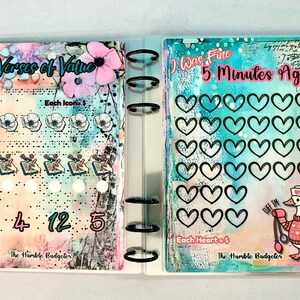 May include: A planner with colorful watercolor backgrounds and text that reads "Verses of Value" and "I Was Fine 5 Minutes Ago!". The planner includes heart and flower icons, numbers, and a cartoon duck with a stethoscope.