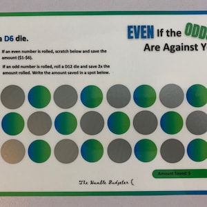 May include: A green and white game board with the text "Roll a D6 die." and "EVEN if the ODDS Are Against You!"  The board has 18 circles, some are green and blue, some are gray. The text "Amount Saved: $ " is at the bottom of the board.