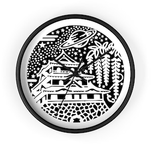 May include: Black and white wall clock with a Japanese castle design, a planet, and stars. The clock has a black frame and hands. The clock face features a detailed illustration of a castle, wisteria, and a planet.