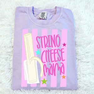 May include: A light purple Comfort Colors sweatshirt with a graphic of a string cheese and the words "STRING CHEESE mama" in pink. The design includes pink stripes, stars, and a string cheese illustration.