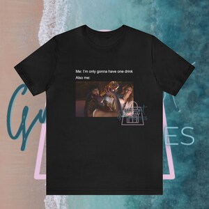 May include: Black t-shirt with a meme about drinking. The text reads "Me: I'm only gonna have one drink. Also me:" and shows a picture of people drinking.