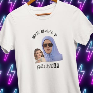 May include: White t-shirt with a graphic of a person wearing a blue hoodie and sunglasses. The text "HER NAME IS RACHEL!" is printed on the shirt.