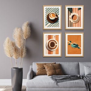 May include: Four framed prints with a minimalist design featuring coffee cups on a striped background. The prints are arranged in a grid pattern on a gray wall above a gray couch with brown throw pillows.