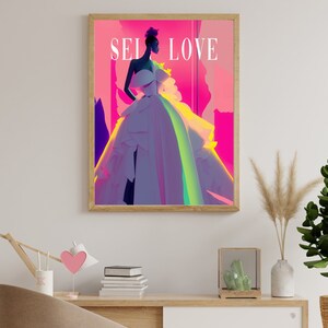 May include: A framed print of a woman in a white dress with a pink, purple, and green background. The text "SELF LOVE" is printed in white on the top of the image.