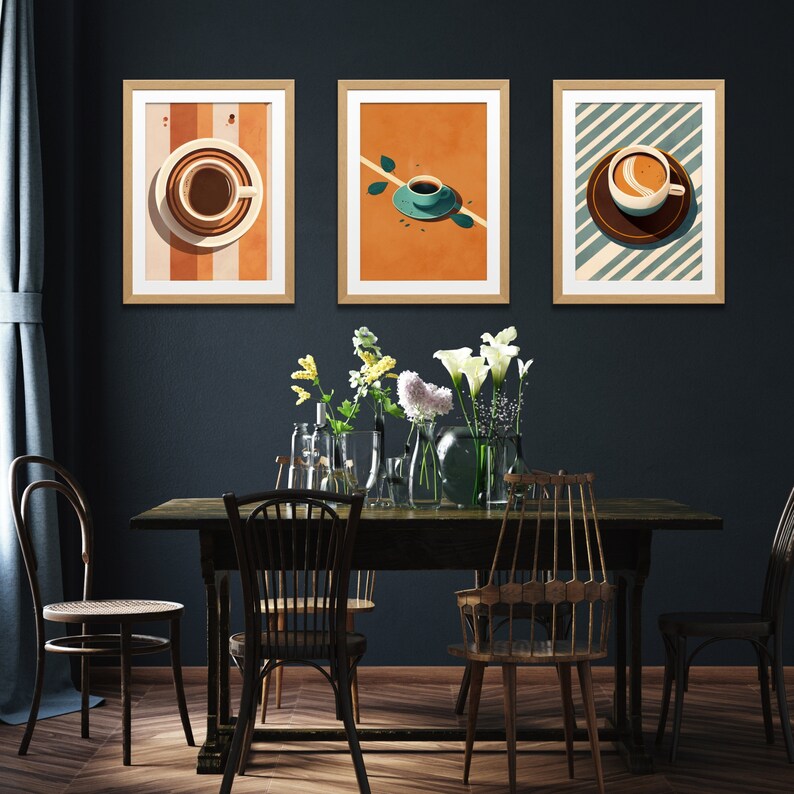 May include: Three framed prints with a minimalist design featuring coffee cups on a colorful background. The prints are hung on a dark blue wall above a wooden table with chairs.