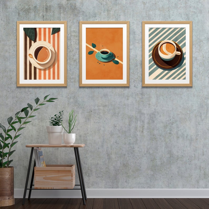 May include: Three framed prints of coffee cups on different backgrounds. The first print has a striped background with a brown and white coffee cup. The second print has an orange background with a green coffee cup. The third print has a blue and white striped background with a brown coffee cup.